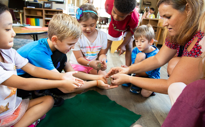 Kids holding a Reptile under the Pets In the Classroom program