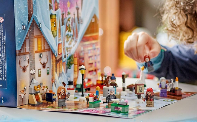 A Child Playing with a LEGO Harry Potter 2023 Advent Calendar