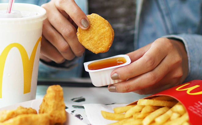 Lady Dipping Her McNugget in Sweet Sour Sauce