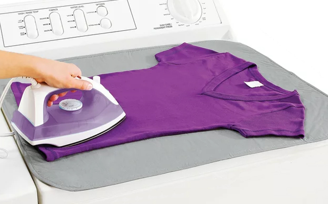Mainstays Silicone Coated Ironing Mat on top of a Washing Machine