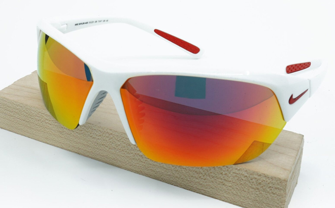 Nike White Red Mirror Skylon Ace Wrap Sunglasses on a Wooden Board