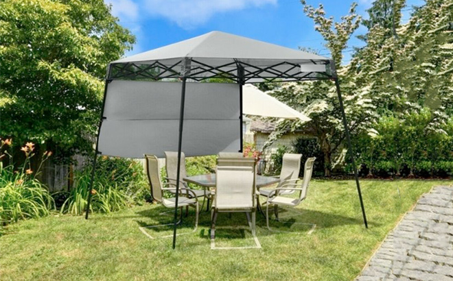 Slant Leg 7 x 7 Pop up Canopy with Carrying Bag in a yard