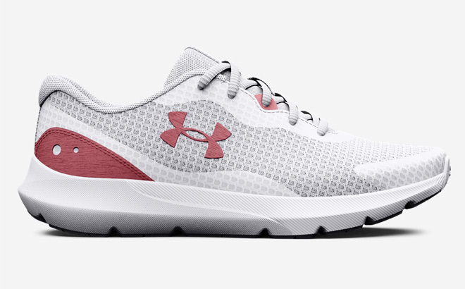 Under Armour Surge Running Shoes for Women in Pink Elixir color on a light gray background