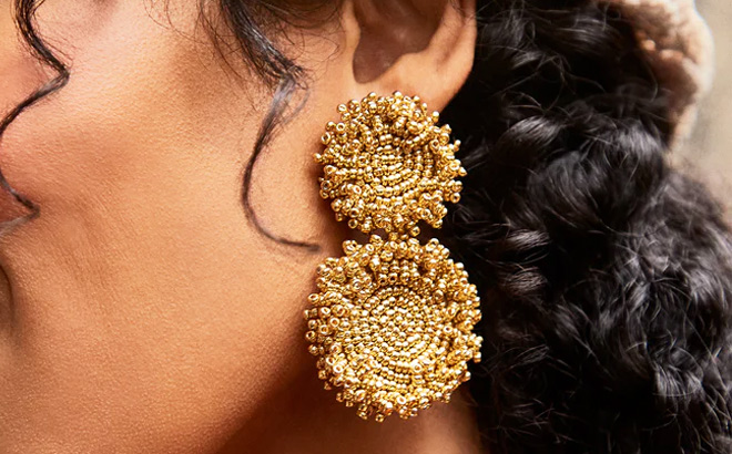 Woman is Wearing a Erin Earrings in Gold color