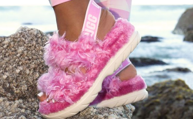 Woman is Wearing a UGG Fluff Sugar Sandal in Pink color