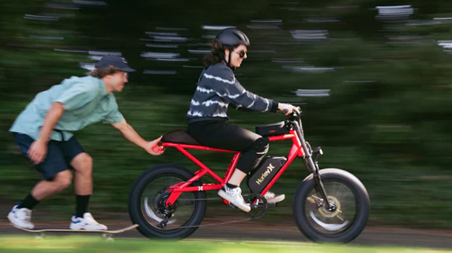 Woman riding a Hurley Bike with Hurley Helmet on