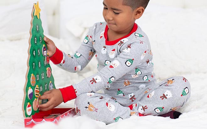 a Boy Holding a Melissa Doug Countdown to Christmas Wooden Advent Calendar