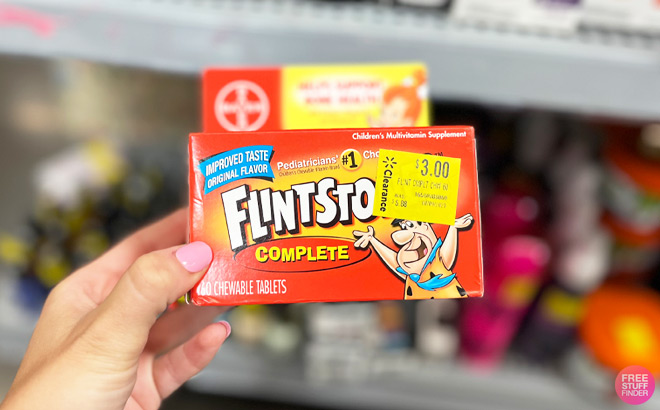 a Hand Holding Flintstones Gummies 60 Count Pack