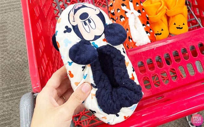 a Hand Holding a Toddler Mickey Mouse Slippers