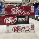 3 Dr Pepper Soda Cans 12 Packs on the Floor