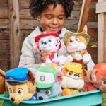 A Boy Playing with the whole Paw Patrol Plushie Family