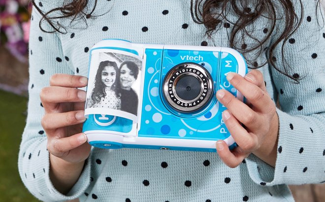 A Girl Holding VTech KidiZoom PrintCam Digital Camera A Girl Holding VTech KidiZoom PrintCam Digital Camera
