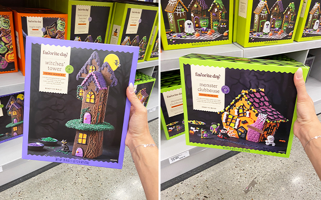 A Hand Holding Favorite Day Halloween Ready to Decorate Chocolate Cookie Witchs Tower Kit and Halloween Ready to Decorate Sugar Cookie Monster Club House Kit