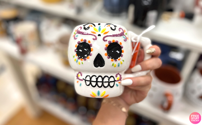 A Hand Holding a Die De Los Muertos Sugar Skull Mug