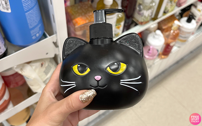 A Hand Holding a Halloween Cat Face Soap Dispenser