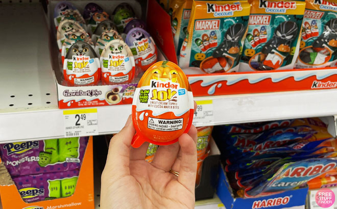 A Hand Holding a Kinder Joy Halloween Candy Eggs