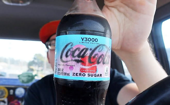 A Man Holding a Coca Cola Y3000 Drink