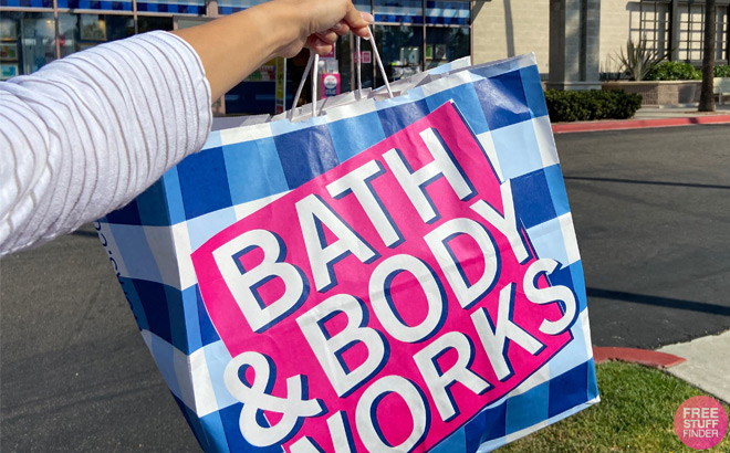 A Person Holding a Bath and Body Works Shopping Bag in Front of the Store