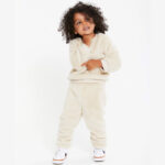 Boy is Wearing a Wonder Nation Cozy Faux Sherpa Outfit Set in Bleached Beige Color