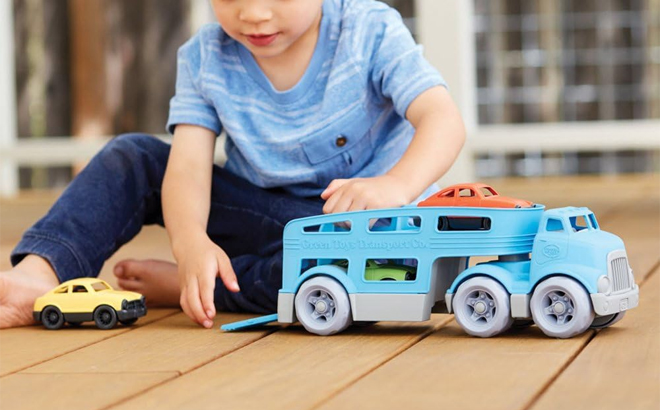 Child Playing with Green Toys Car Carrier