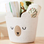 Cloud Island Small Sleepy Bear Rope Round Basket Filled with Blankets on a Table