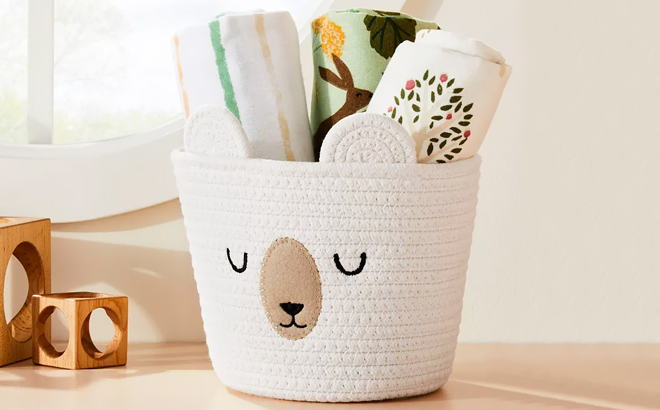 Cloud Island Small Sleepy Bear Rope Round Basket Filled with Blankets on a Table