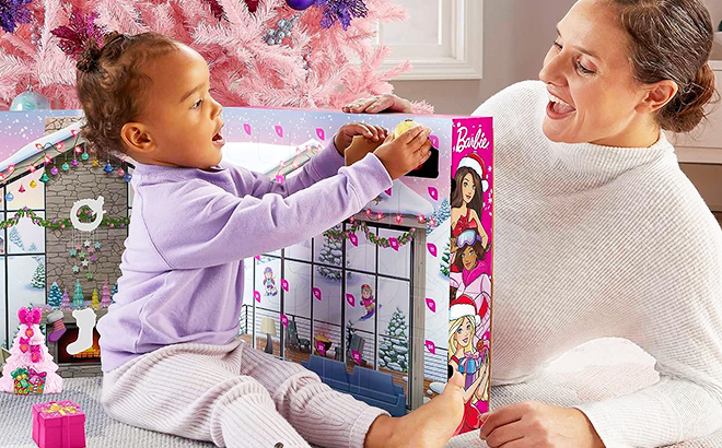 An Adult and a Child Playing with the Fisher-Price Little People Barbie Advent Calendar