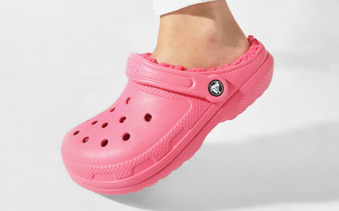 Girl Wearing a Crocs Classic Lined Clog in Hyper Pink color