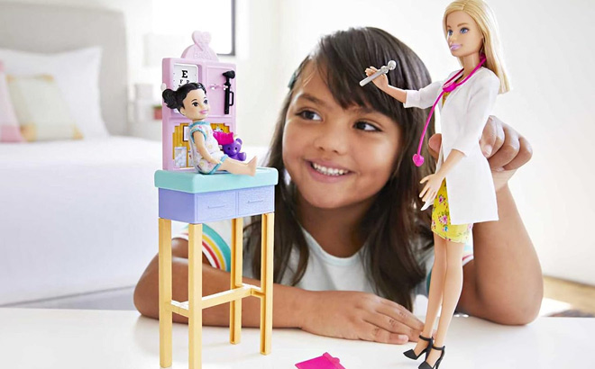 Girl is Playing with Barbie Careers Doll Playset