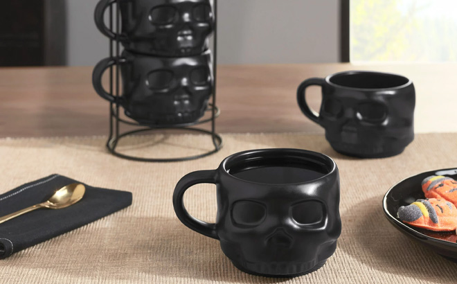 Halloween Black Skull Shaped Glazed Ceramic Stacking Mug Set with Metal Rack on the Table