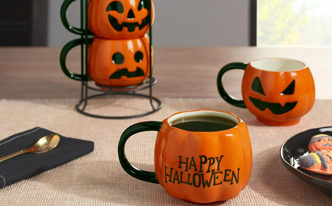 Halloween Orange and Black Pumpkin Shaped Glazed Ceramic Mug Set with Metal Rack on the Table