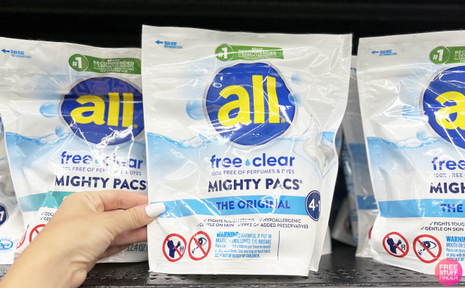 Hand Holding All Mighty Pacs Free Clear Laundry Detergent