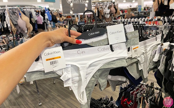 Hand Holding Calvin Klein Panties in a Store Aisle