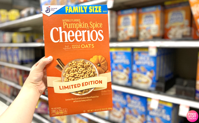 Hand Holding General Mills Pumpkin Spice Cheerios Family Size Cereal Box