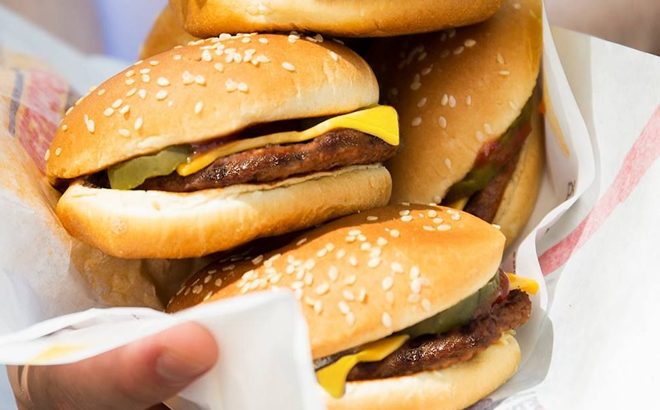 Hand Holding Multiple Burger King Cheeseburgers