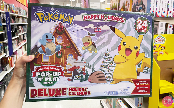 A Hand Holding the 42-piece Pokemon Deluxe Holiday Calendar at Target