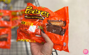 Hand Holding Reeses Snack Size Cups Candy Bag