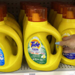 Hand Holding Tide Simply Clean Fresh Liquid Laundry Detergent