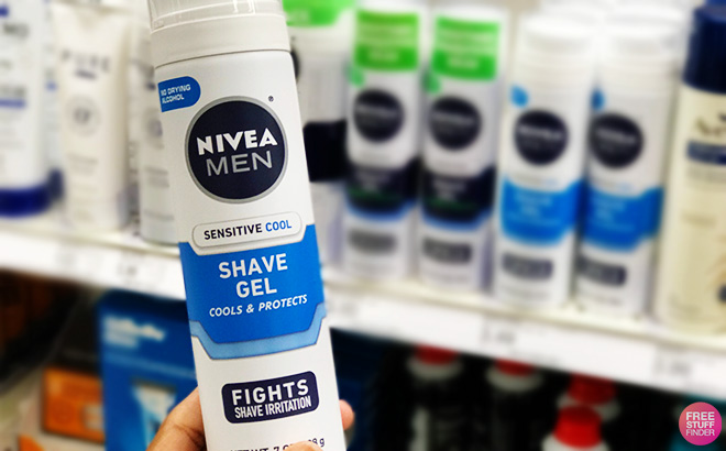 Hand Holding a Nivea Men Sensitive Cool Shave Gel in a Store Aisle