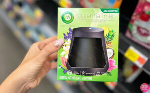 Hand Holding the Air Wick Essential Mist Diffuser in a Walmart Aisle 1 1