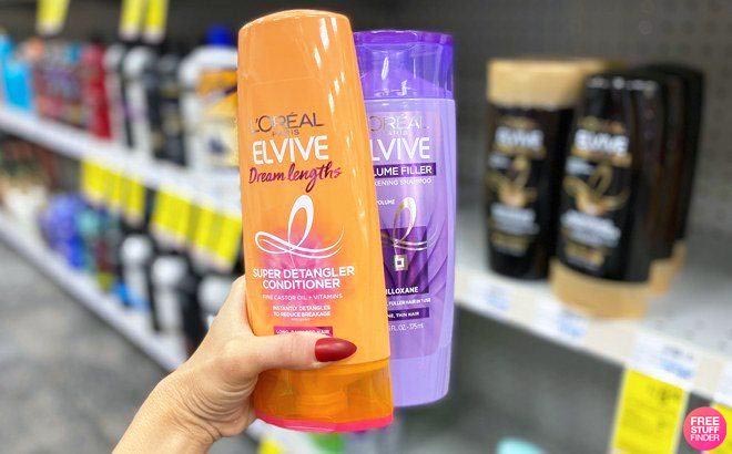 Hand holding LOreal Elvive Shampoo and Conditioner