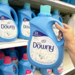 Hand holding a Downy 120 Load Ultra Laundry Fabric Softener in cool cotton scent
