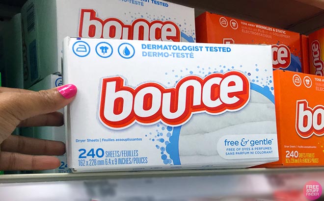 Hand holding one Bounce Free and Gentle Dryer Sheets 200 Count