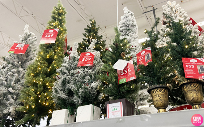 Nine Different Artificial Christmas Trees on a Store Shelf