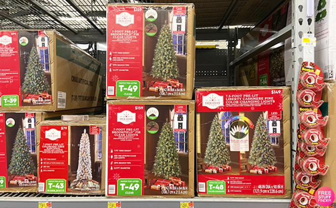 Several Artificial Christmas Trees on a Store Shelf
