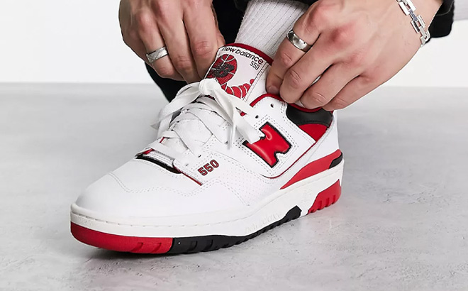 Man is Wearing New Balance 550 Sneakers in White With Team Red Color