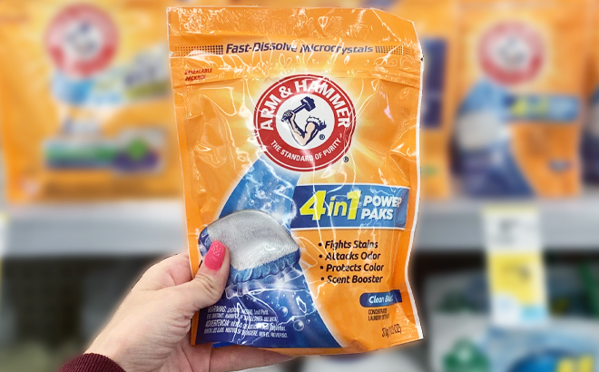 Person Holding a Bag of Arm Hammer 4 in 1 Laundry Detergent Power Paks