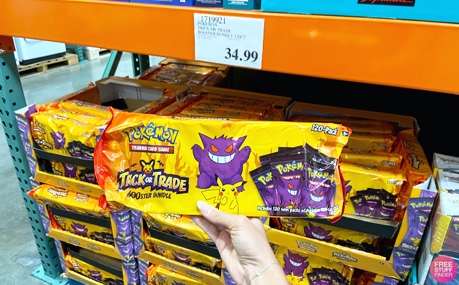 Person Holding a Pokemon Halloween Trick or Trade Booster Bundle
