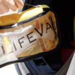 Person Placing a LifeVac Choking Rescue Kit in a Car Trunk