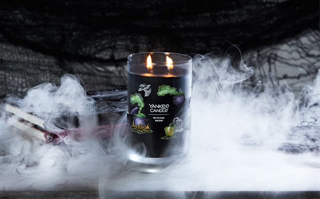 Signature Large Tumblr Witches Brew Yankee Candle Displayed on Books and Surrounded by Smoke